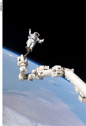 Dr. Naledi Vermaak on a robotic arm during a spacewalk